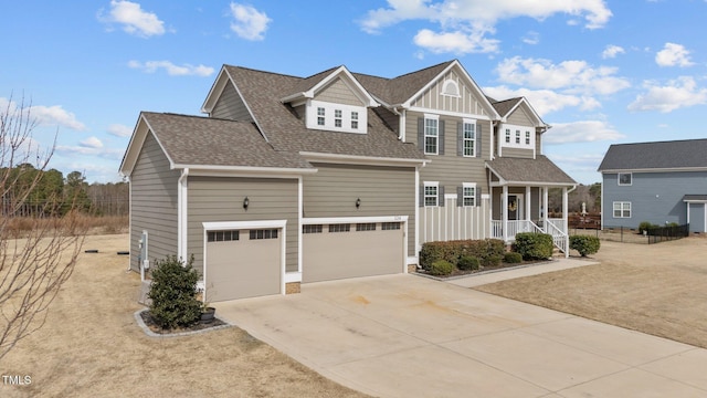 view of front facade featuring concrete driveway, board and batten siding, and roof with shingles