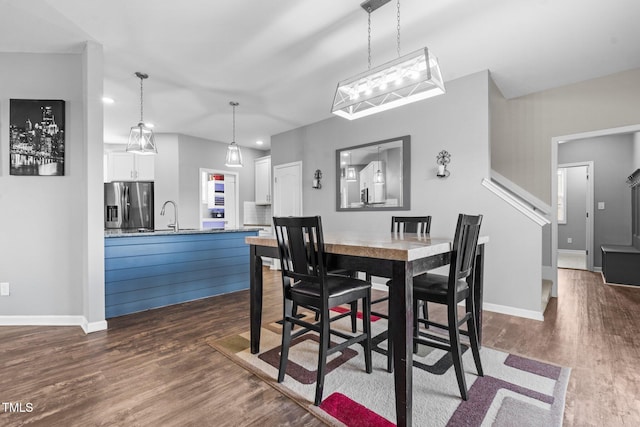 dining area with dark wood-type flooring and baseboards