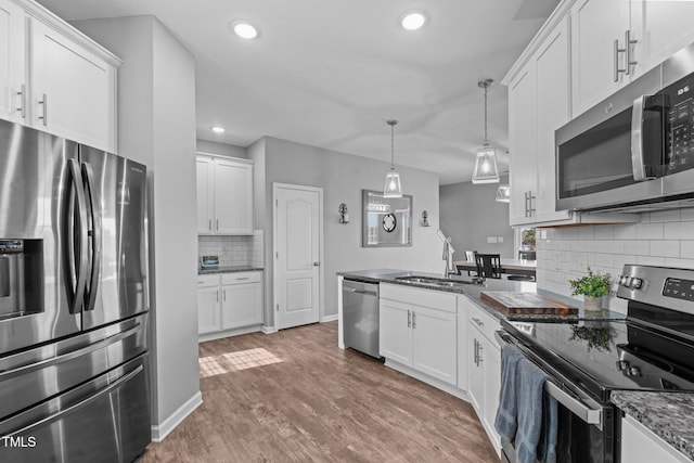 kitchen with light wood-style floors, white cabinetry, and appliances with stainless steel finishes