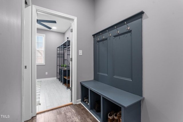 mudroom featuring baseboards and wood finished floors