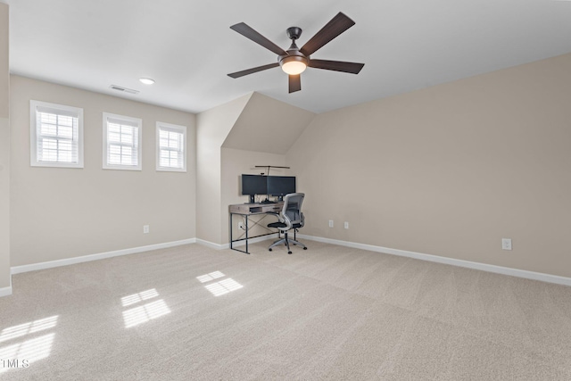 unfurnished office with carpet floors, visible vents, a ceiling fan, vaulted ceiling, and baseboards