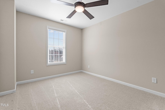 carpeted empty room featuring visible vents, ceiling fan, and baseboards