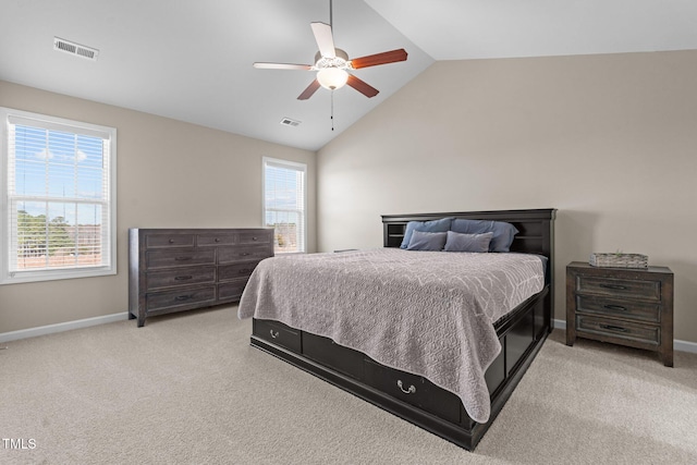 carpeted bedroom featuring lofted ceiling, multiple windows, visible vents, and baseboards