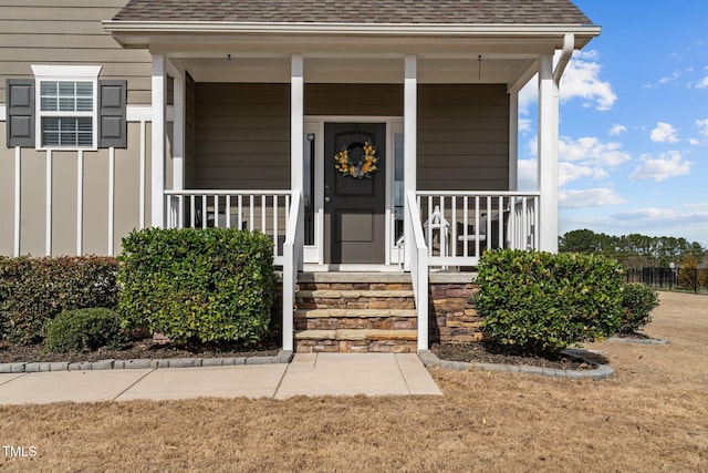 property entrance featuring a porch and roof with shingles