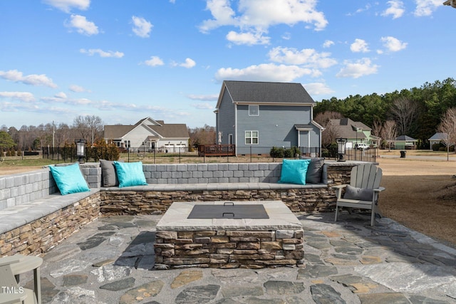 view of patio / terrace featuring fence and a fire pit