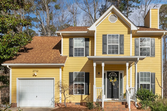 traditional-style house with an attached garage, roof with shingles, and crawl space