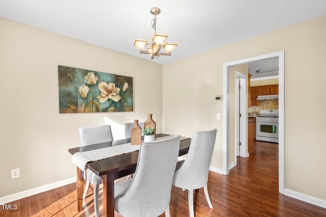 dining room featuring baseboards, an inviting chandelier, and wood finished floors