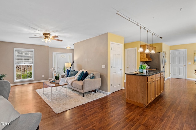 living room featuring a ceiling fan, baseboards, and dark wood-style flooring