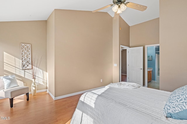 bedroom with baseboards, ensuite bathroom, light wood-style floors, high vaulted ceiling, and a ceiling fan