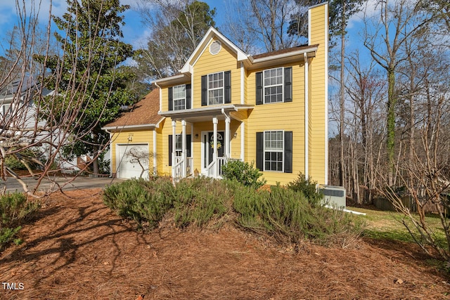 view of front of property with a garage and a chimney