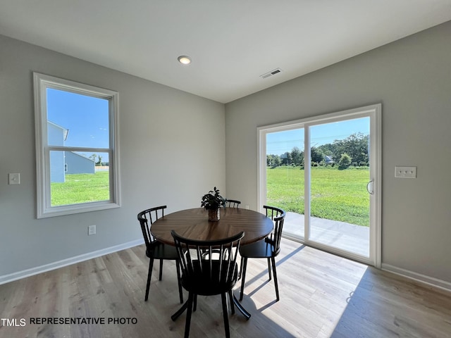 dining area featuring healthy amount of natural light, baseboards, and light wood-type flooring