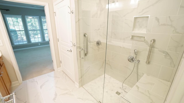 full bath with a shower stall, crown molding, vanity, and marble finish floor