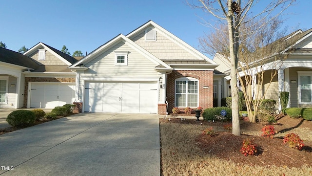 craftsman inspired home featuring brick siding, concrete driveway, and an attached garage