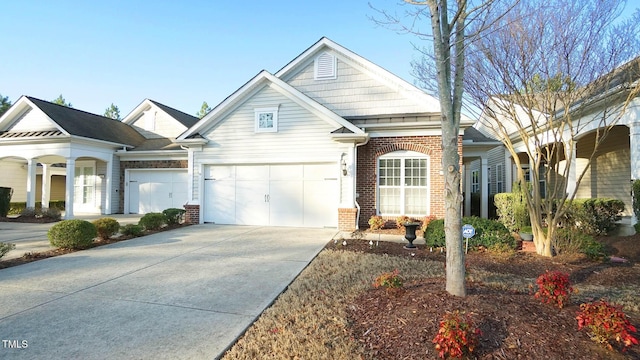 view of front of home featuring concrete driveway and brick siding