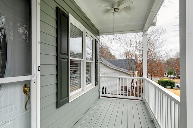 wooden deck featuring a porch and ceiling fan