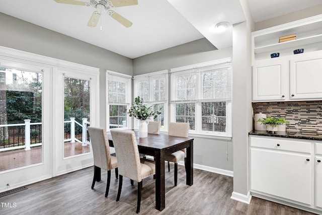 dining room with visible vents, ceiling fan, baseboards, and wood finished floors