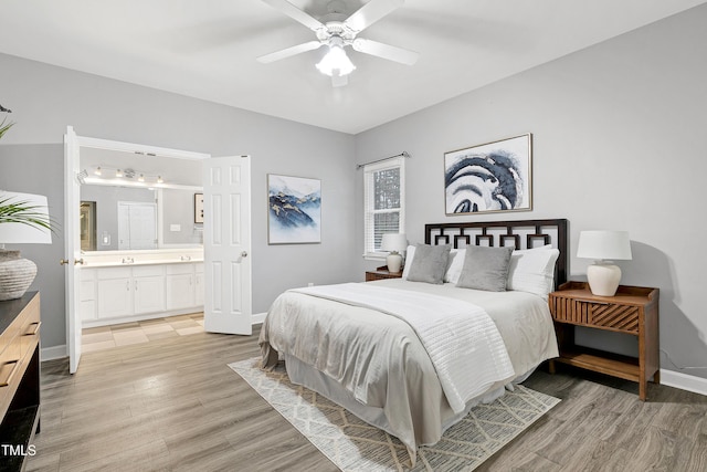 bedroom featuring ceiling fan, light wood finished floors, ensuite bath, and baseboards