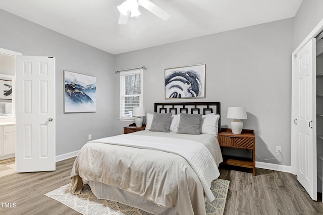 bedroom with light wood-type flooring, baseboards, and a ceiling fan