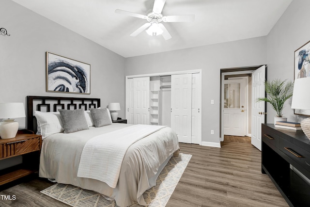 bedroom with a ceiling fan, a closet, baseboards, and wood finished floors