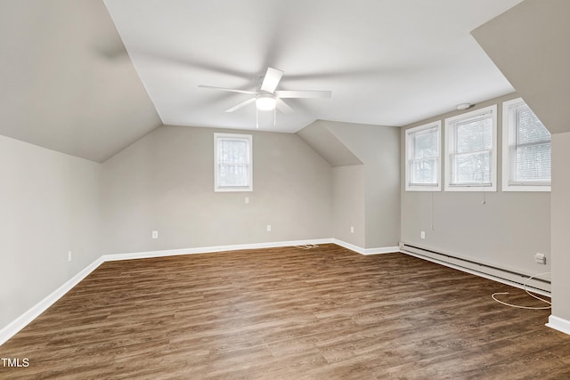 bonus room with lofted ceiling, baseboards, baseboard heating, and wood finished floors