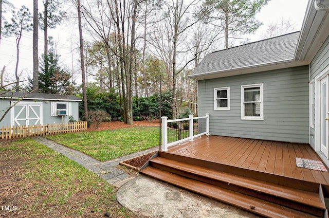 wooden deck with a yard and an outdoor structure