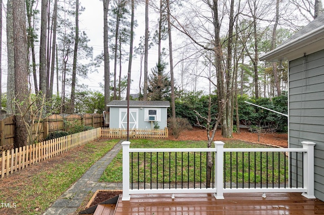 view of yard featuring an outbuilding, a storage unit, and fence