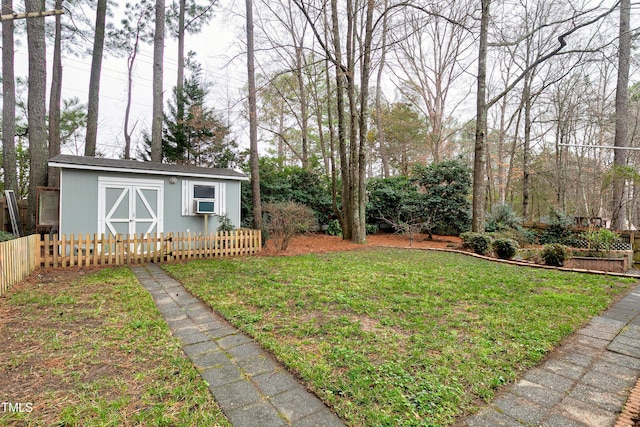 view of yard with a shed, an outdoor structure, and fence