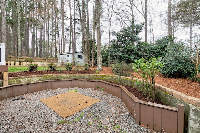 view of yard with fence, a patio, and an outbuilding