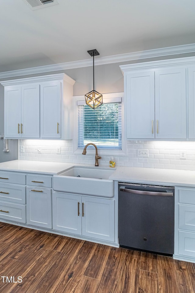 kitchen featuring dark wood-style floors, light countertops, stainless steel dishwasher, and a sink