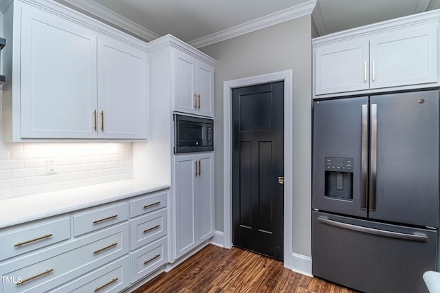 kitchen featuring tasteful backsplash, stainless steel fridge, dark wood-type flooring, crown molding, and black microwave