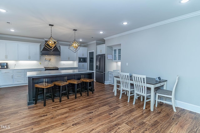 kitchen featuring tasteful backsplash, custom range hood, stainless steel appliances, and dark wood-type flooring