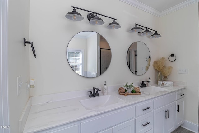 full bath featuring double vanity, a sink, and crown molding