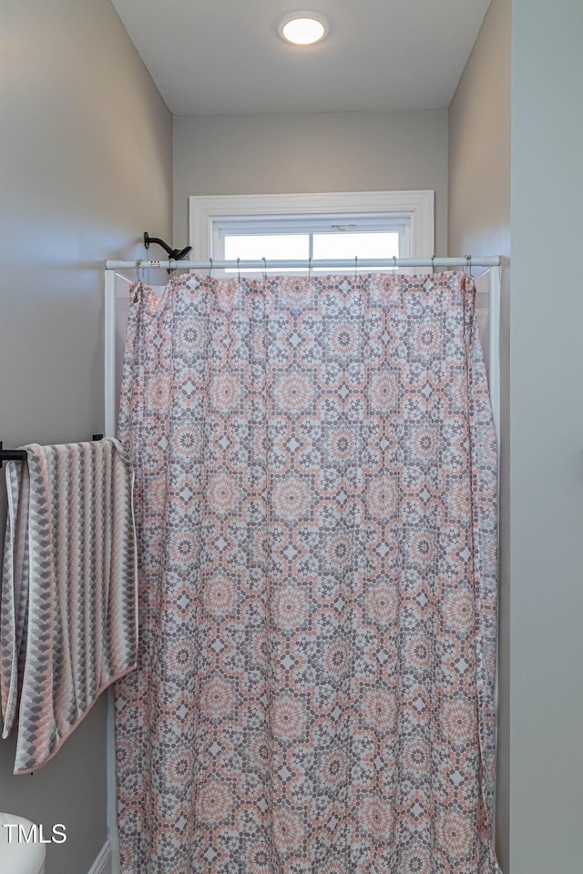 bathroom with a shower with shower curtain