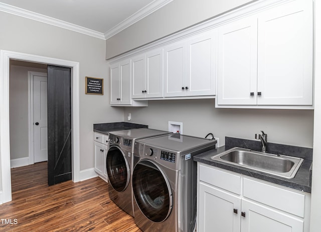 clothes washing area featuring crown molding, cabinet space, dark wood-type flooring, a sink, and independent washer and dryer