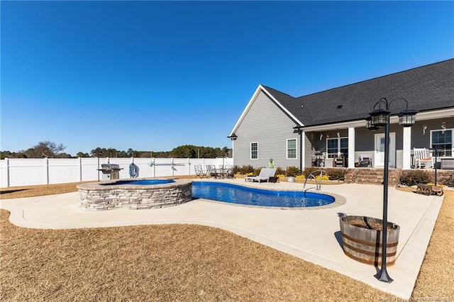 view of swimming pool with an in ground hot tub, a patio area, a fenced backyard, and a fenced in pool