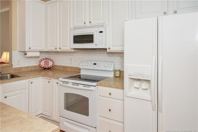 kitchen with white appliances, white cabinets, backsplash, and light countertops