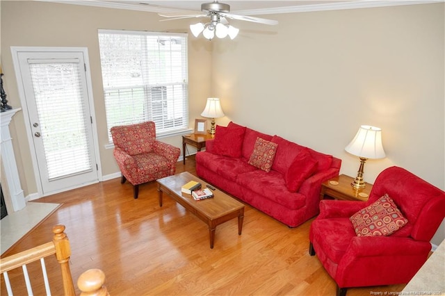 living room featuring wood finished floors, a high end fireplace, and crown molding