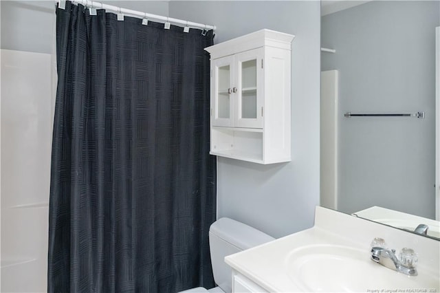 bathroom with vanity, toilet, and a shower with curtain