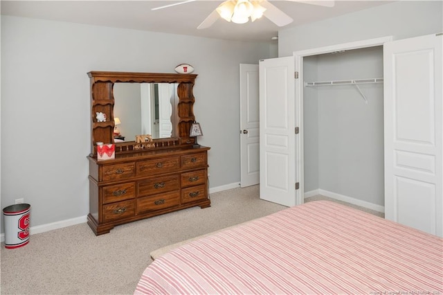 carpeted bedroom with a closet, a ceiling fan, and baseboards