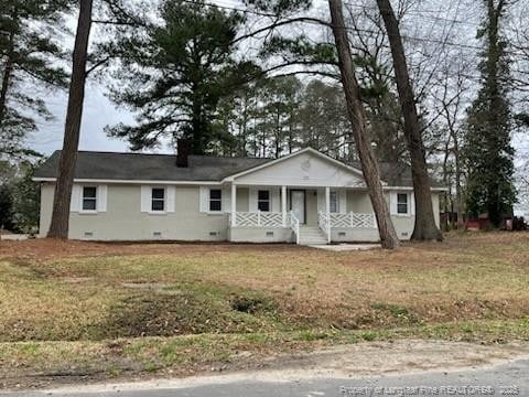 ranch-style house with a porch, crawl space, a chimney, and a front lawn