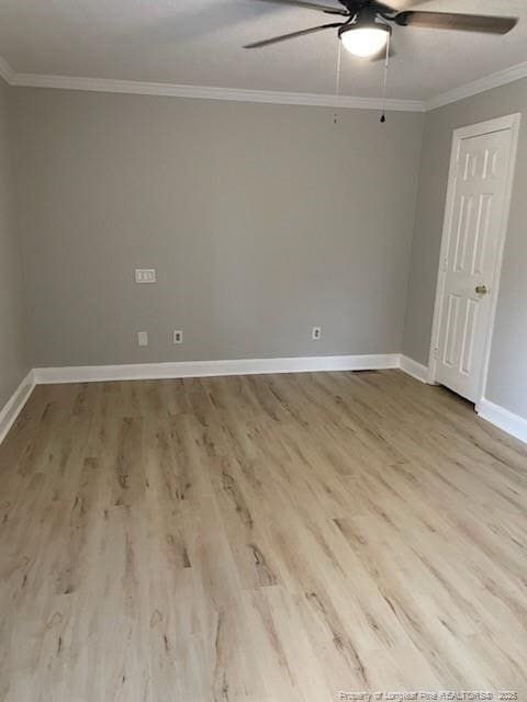 empty room featuring ceiling fan, ornamental molding, wood finished floors, and baseboards