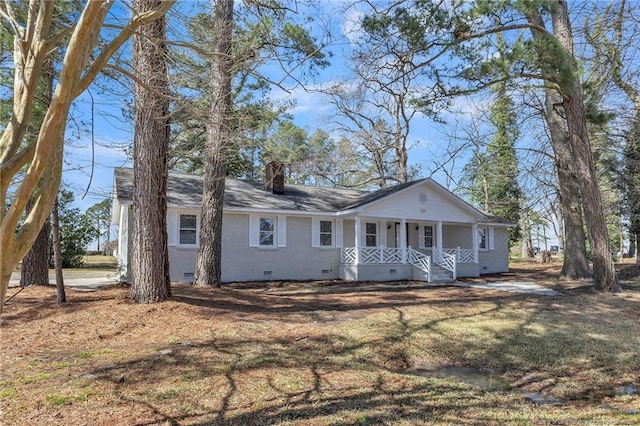 view of front of house with covered porch, roof with shingles, crawl space, a front lawn, and a chimney