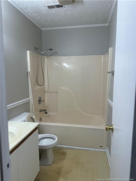 full bath featuring visible vents, toilet, a textured ceiling, vanity, and shower / bathing tub combination