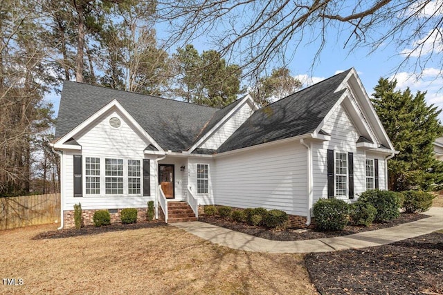 view of front of house featuring crawl space, a shingled roof, fence, and a front yard