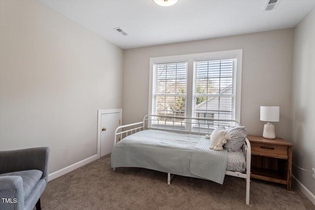 carpeted bedroom featuring baseboards and visible vents