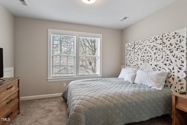 carpeted bedroom featuring baseboards and visible vents