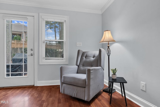 living area with ornamental molding, baseboards, and wood finished floors