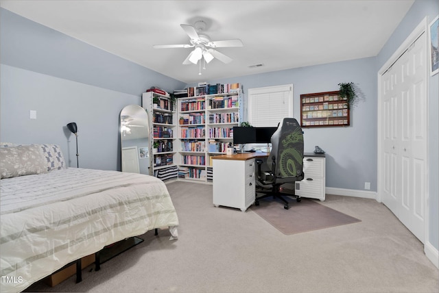 carpeted bedroom with a closet, visible vents, ceiling fan, and baseboards