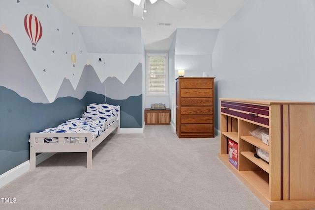 bedroom with lofted ceiling, light colored carpet, visible vents, a ceiling fan, and baseboards