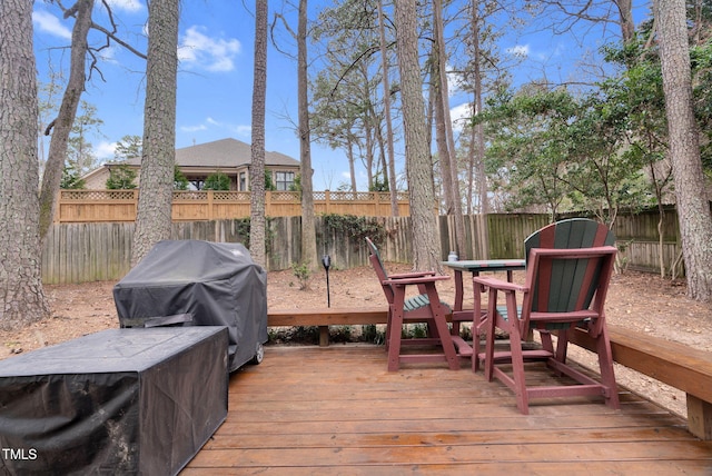 deck featuring a grill and a fenced backyard